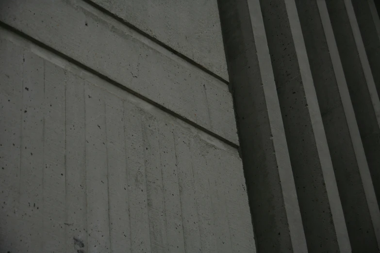 a white clock in a corner of cement