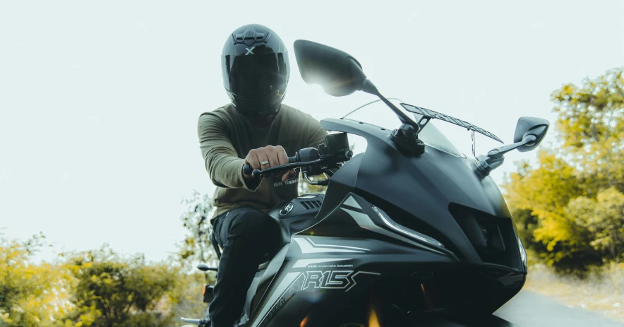a person sitting on a motorcycle with helmet on