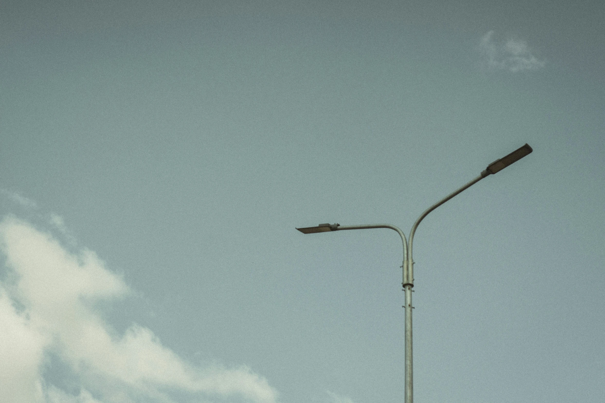 street lamps against a cloudy sky on a cloudy day