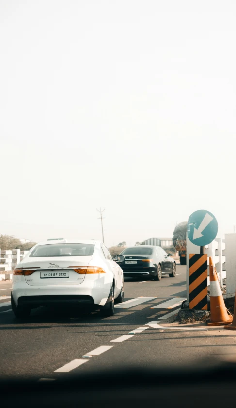 a city street filled with traffic and construction cones