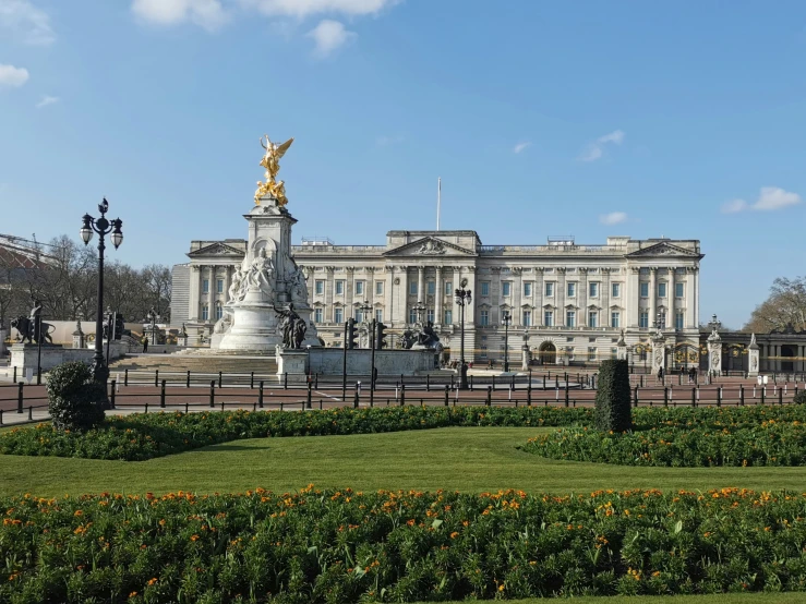 a very tall white building with a golden statue on top