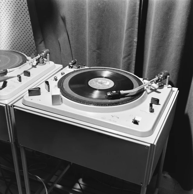 a record player and a mixing unit sit together