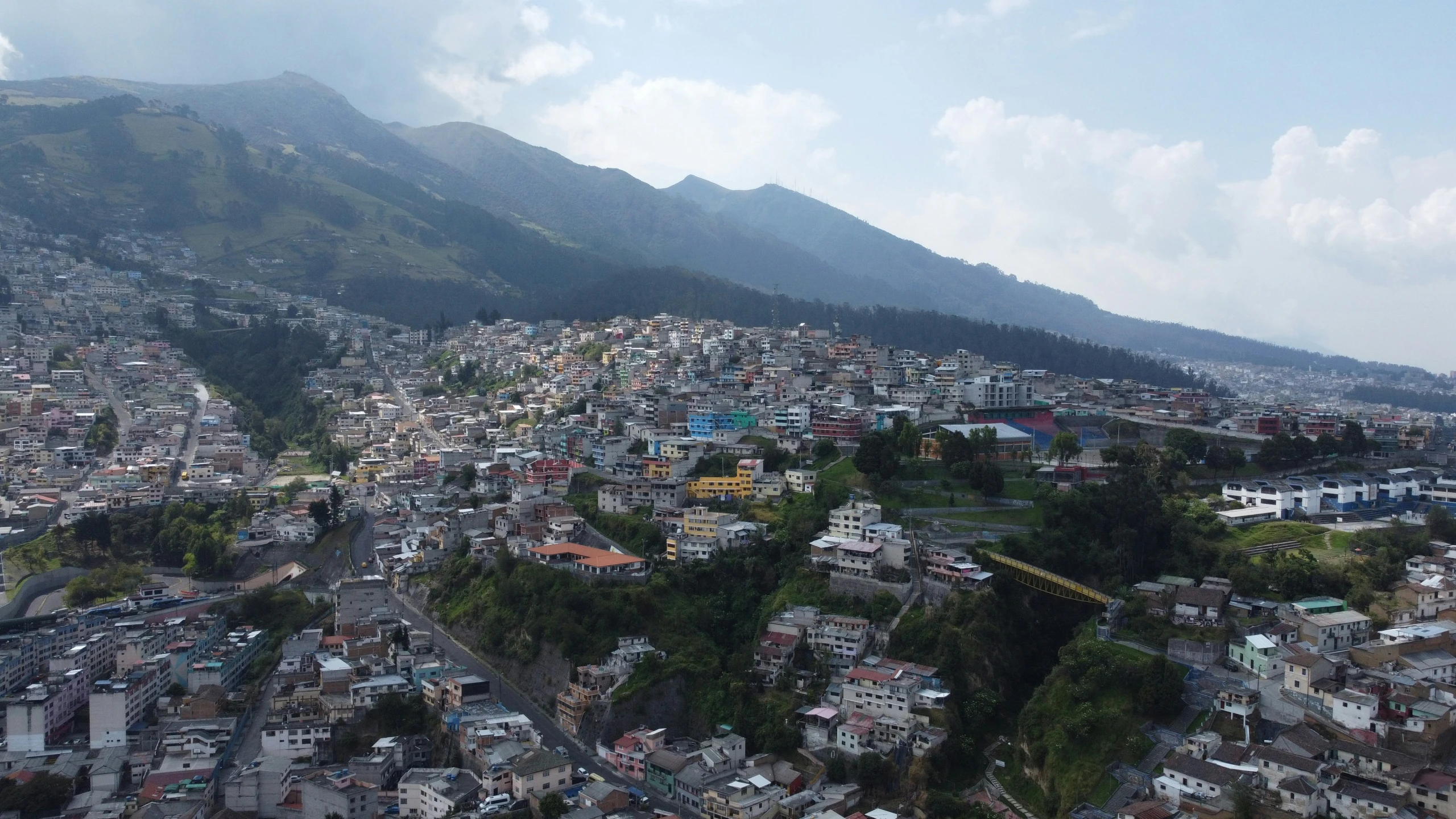 many small buildings are situated at the base of the hills