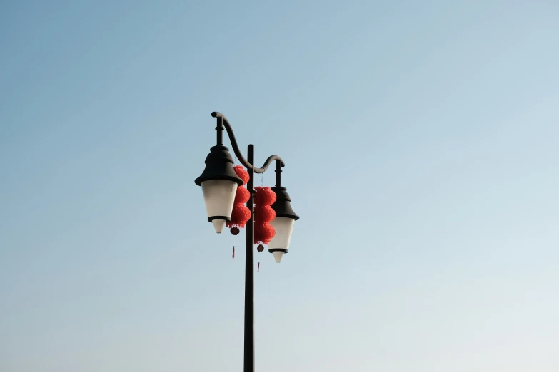 an image of street lamps made of red yarn