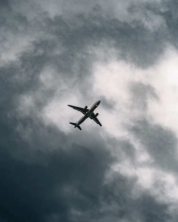 a large passenger airplane flying through a cloudy sky