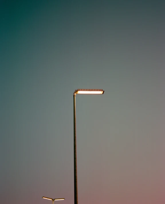 street lamp sitting next to a tall street light