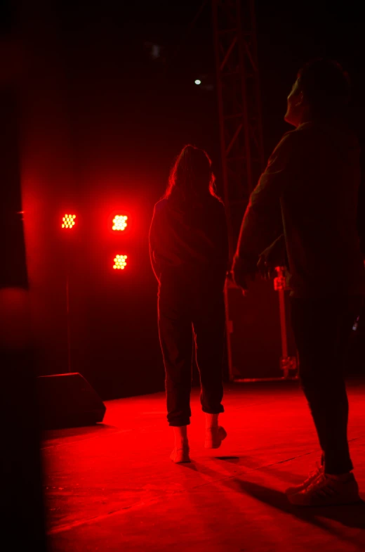 two people walking in the dark at night