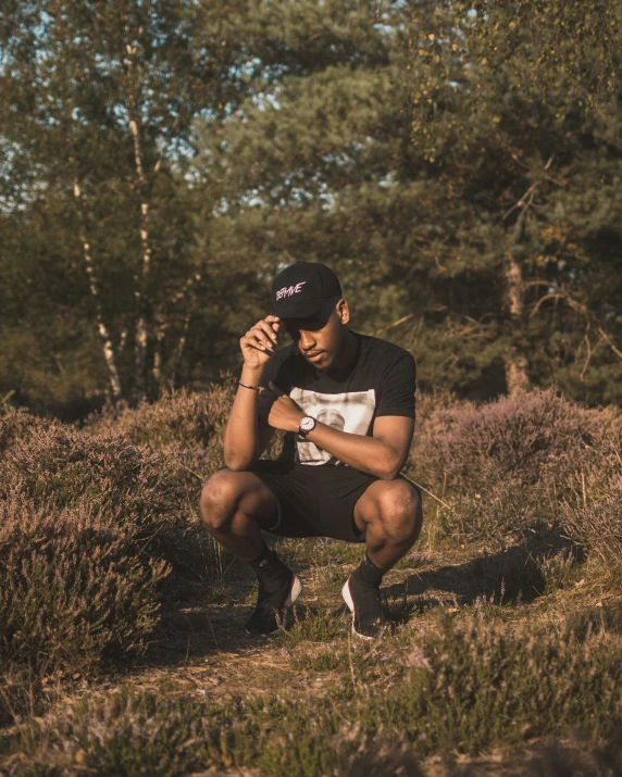 a person sitting in a field with a hat on