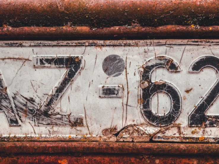 this is an old and rusty, broken license plate