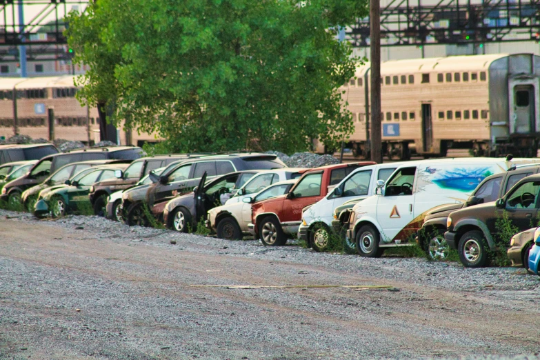 several cars parked on the side of a gravel road