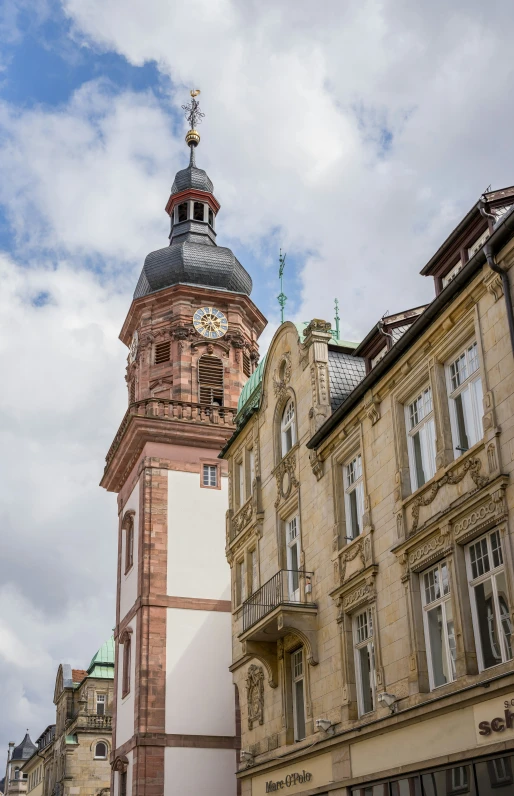 the tall building has an ornate top on it's spire