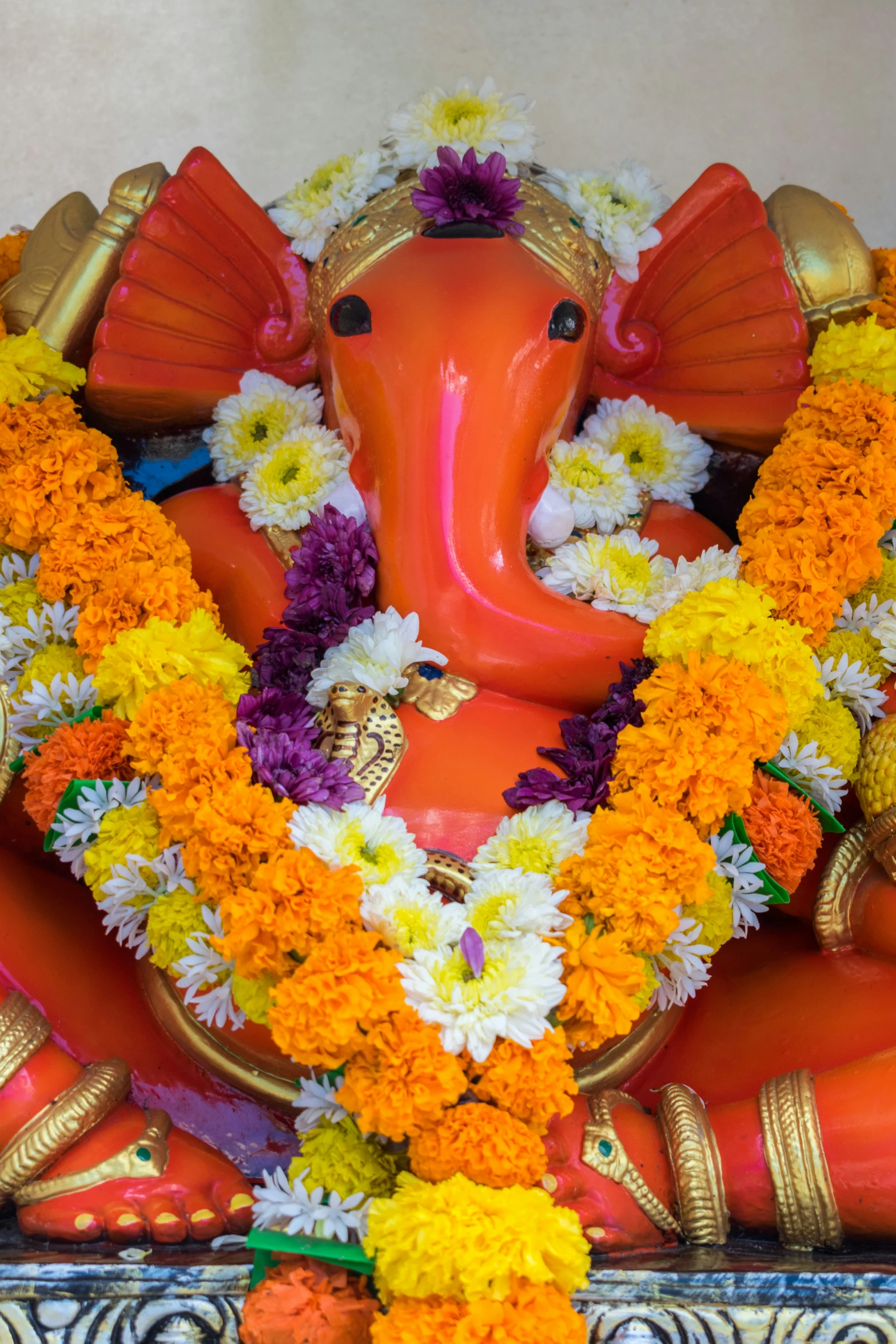 an indian styled elephant statue decorated with flowers