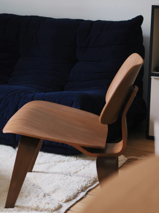 the modern, wooden chair is in the living room