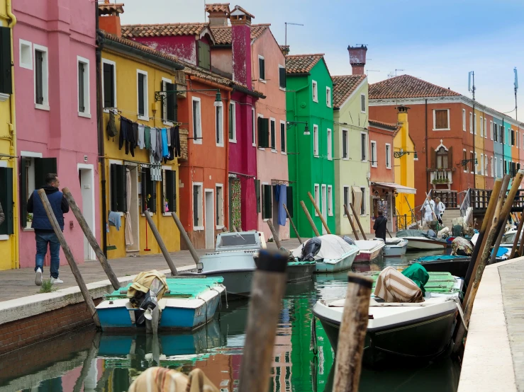 a group of boats on a river next to a shore