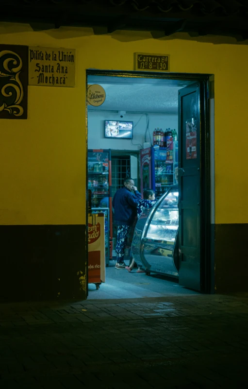 a woman is entering a yellow building by herself