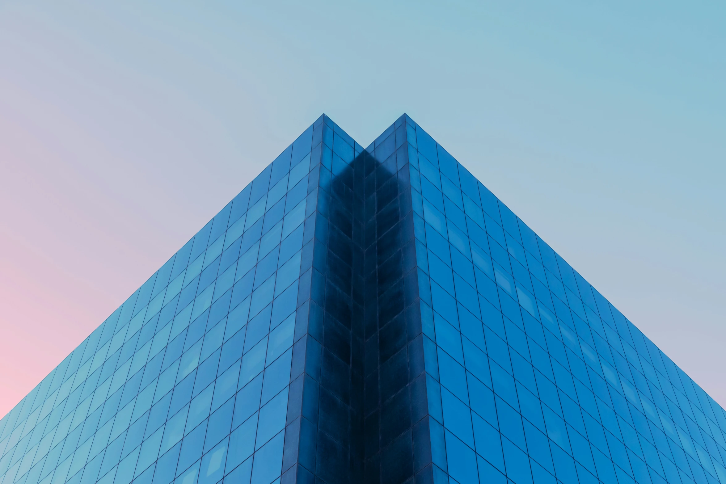 a tall blue building with several windows in front