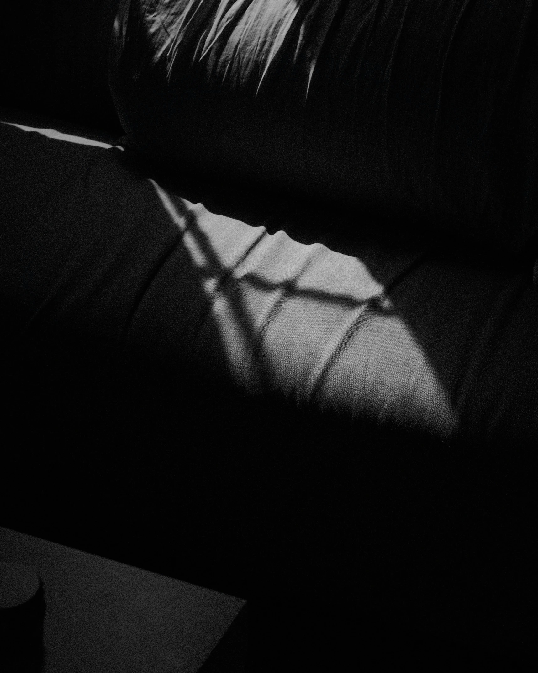 black and white pograph of a window in a dark room