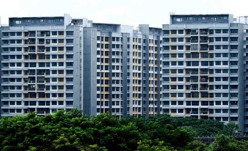 a high rise building with windows near some trees