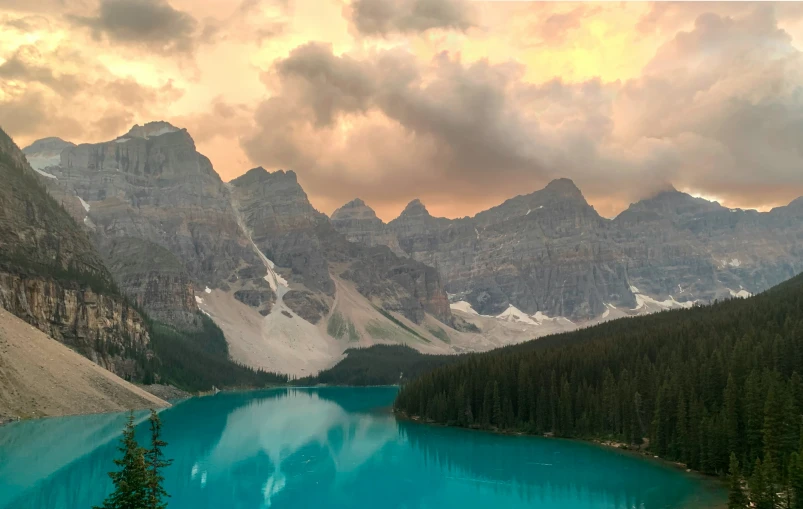 the mountains are seen near a large blue lake