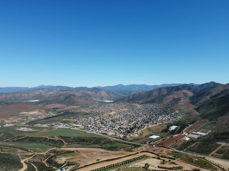 view from above of a city surrounded by mountains