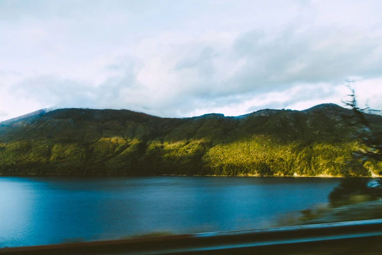 an image of a mountain lake from the window of a car