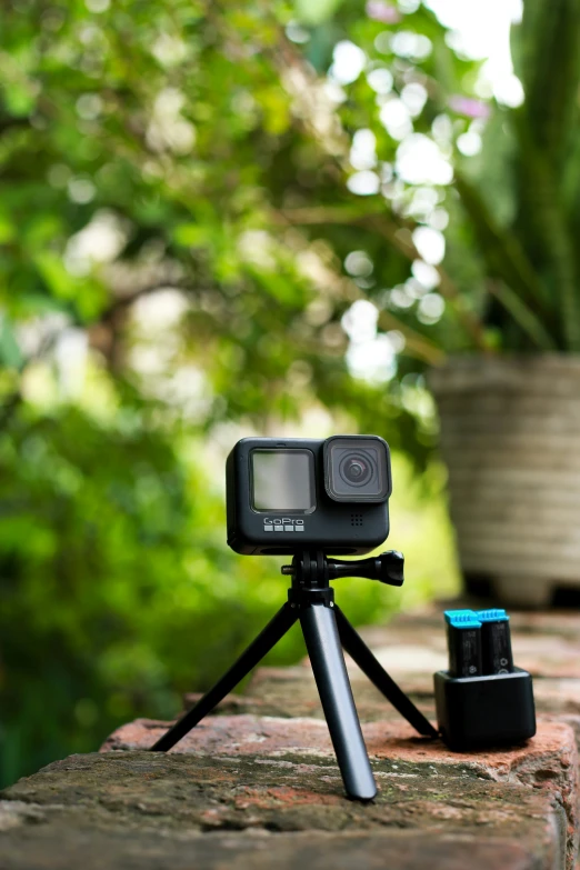 a small camera on a tripod and a case of items