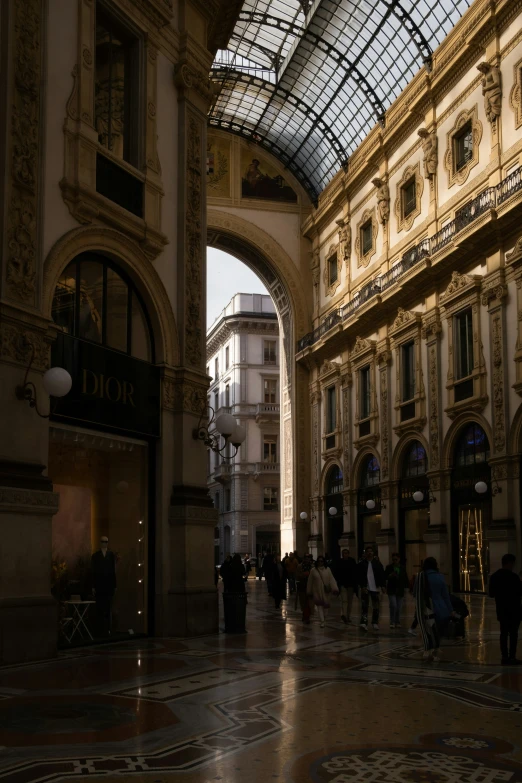 people are walking through a store next to a clock tower