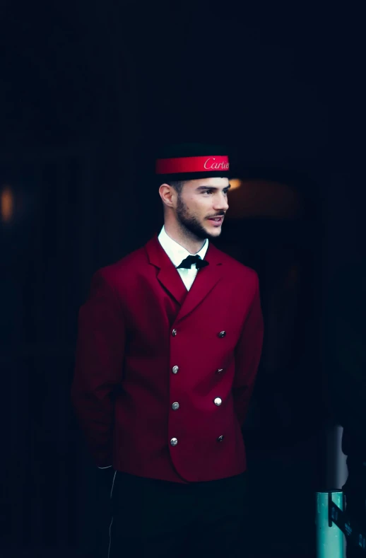 a man in a red jacket is looking around