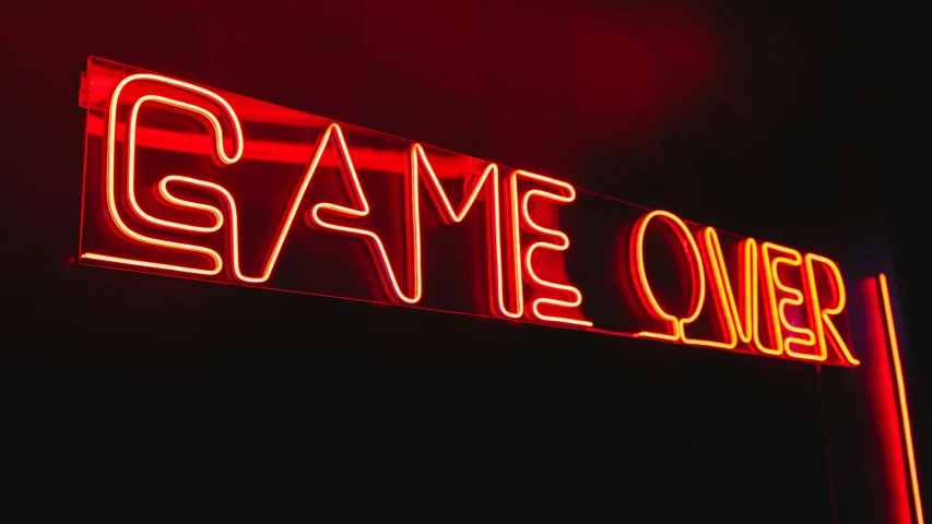 a close up of a neon sign in the dark