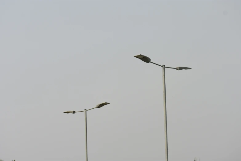 a couple of street lights standing next to each other