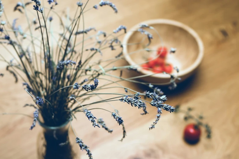 flowers in a vase sitting on the floor