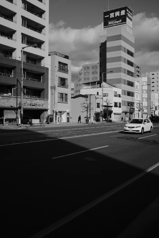 some buildings and cars are on the road