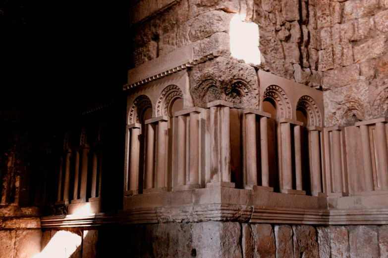 the light shines through a hole in a stone building