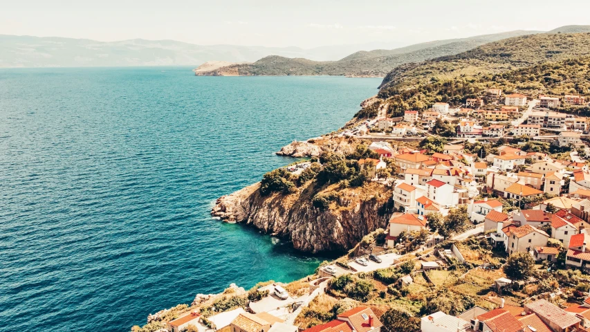 an aerial view of the houses on a cliff