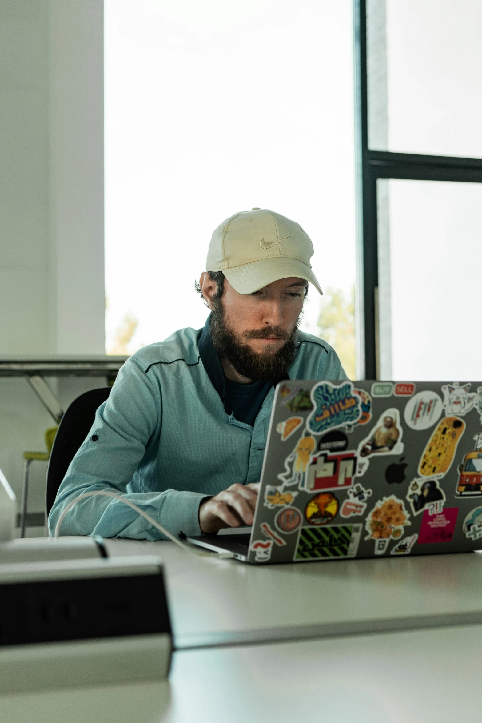 a man that is sitting in front of a laptop