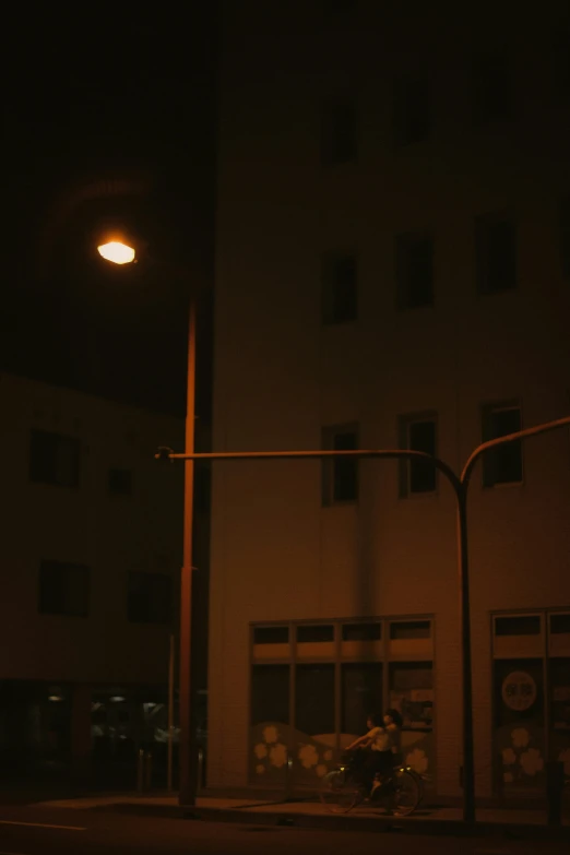 street light on the corner near a building at night