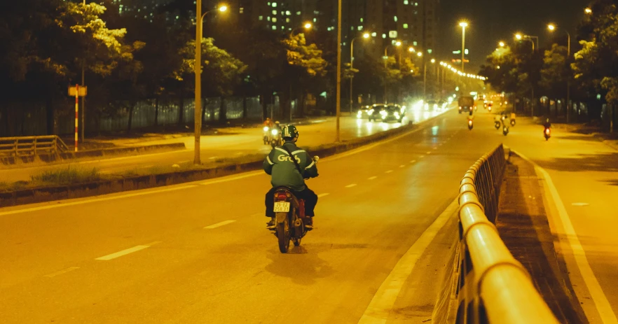 a person riding a motorcycle down the road