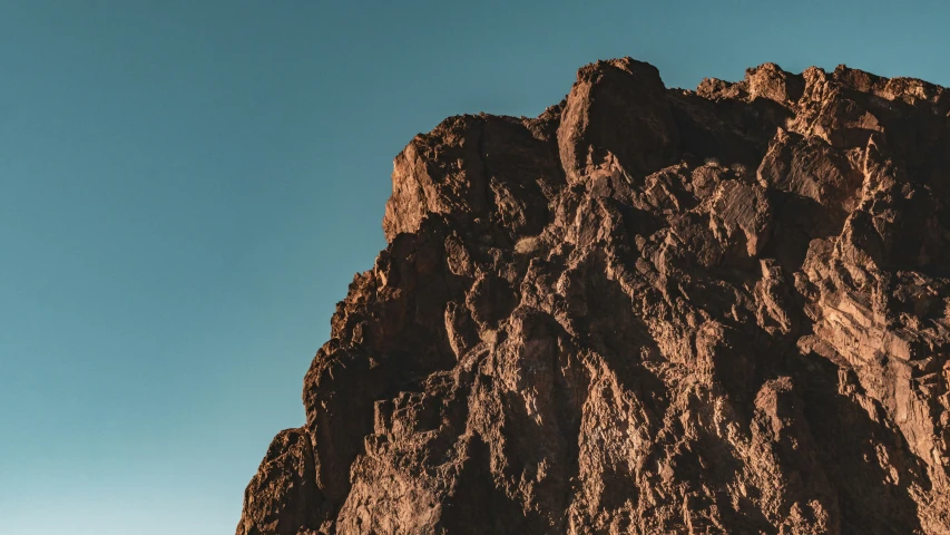 mountains towering over a blue sky in the afternoon