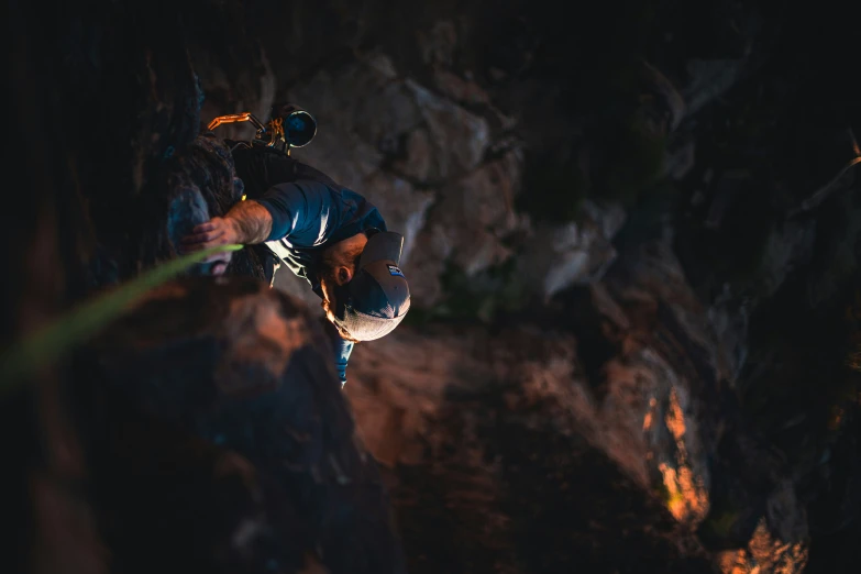 a man climbing up the side of a cliff