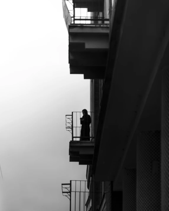 a black and white po of people standing on top of a building