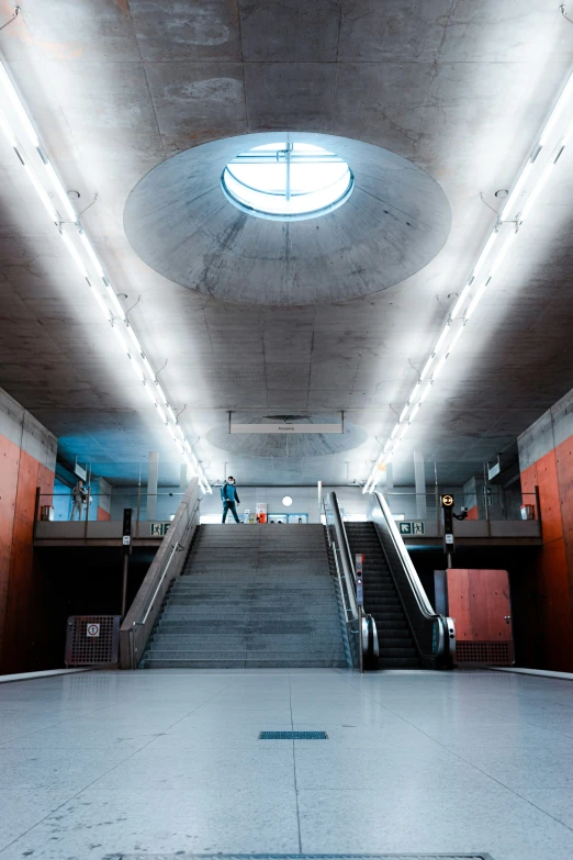 the inside of an indoor train station, with staircases