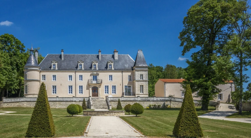 a large home on a bright day with trees in the background