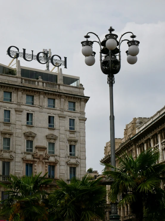 a lamp post with two buildings in the background