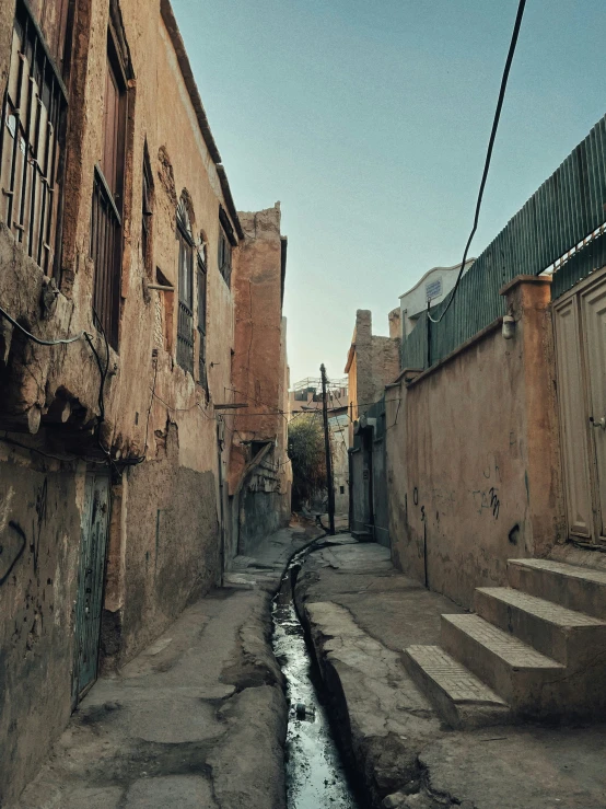 an alley in an old rundown city with small dle