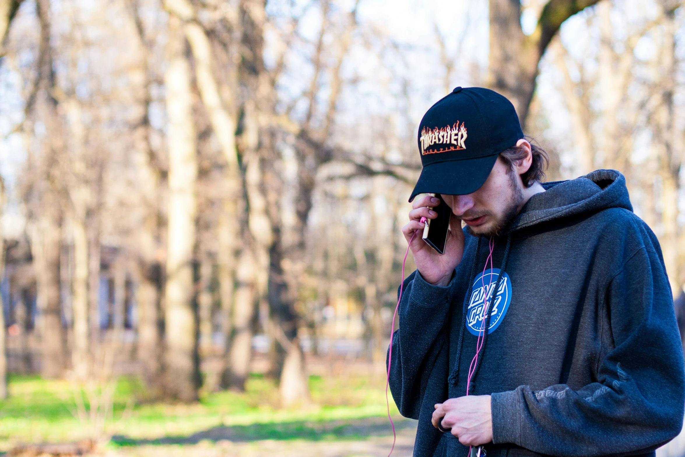 a man wearing a hat talks on his cell phone