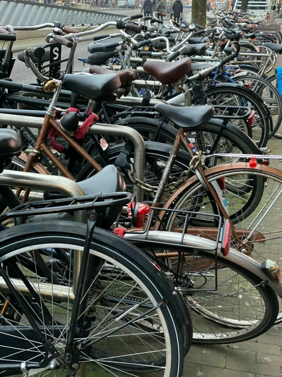 many bikes parked next to each other on the street