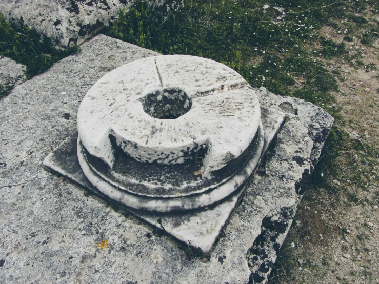 an old broken and filthy stone monument