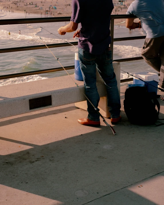 a little boy is standing with his hands out to fishing