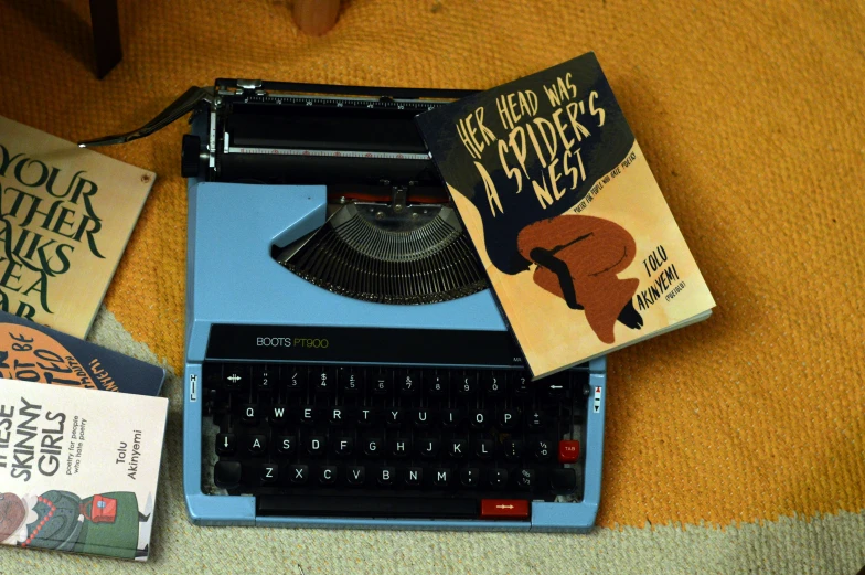 a book and typewriter on a table