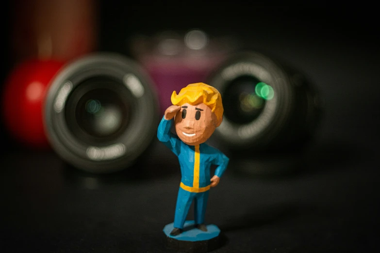 a small toy on a table next to the camera